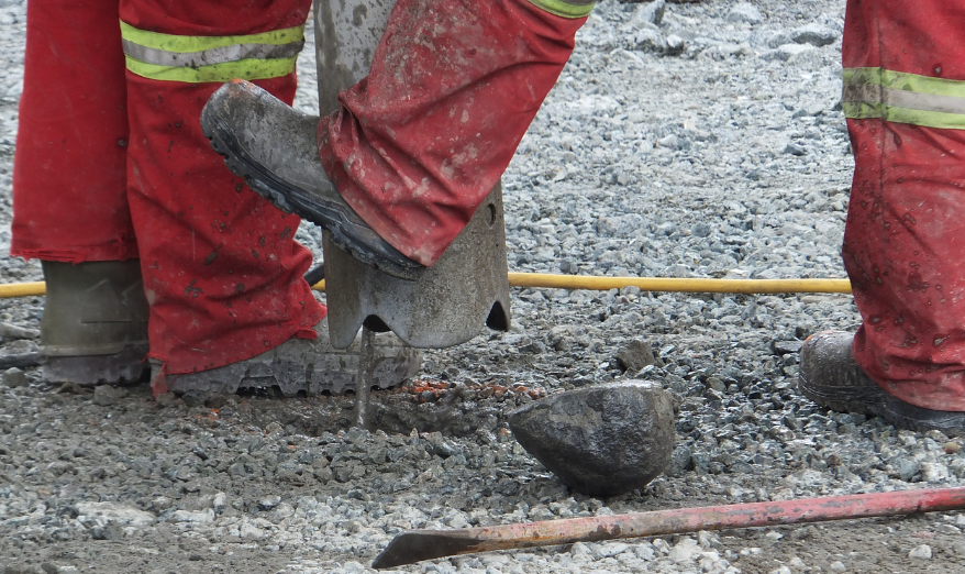 construction workers feet with mud on their boots